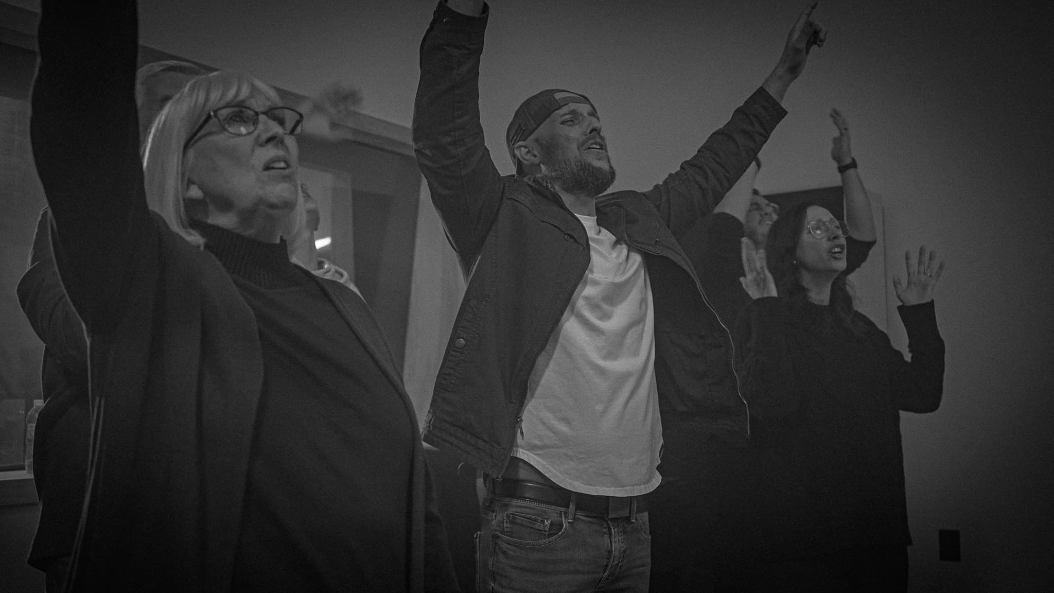 The Collective with hands raised